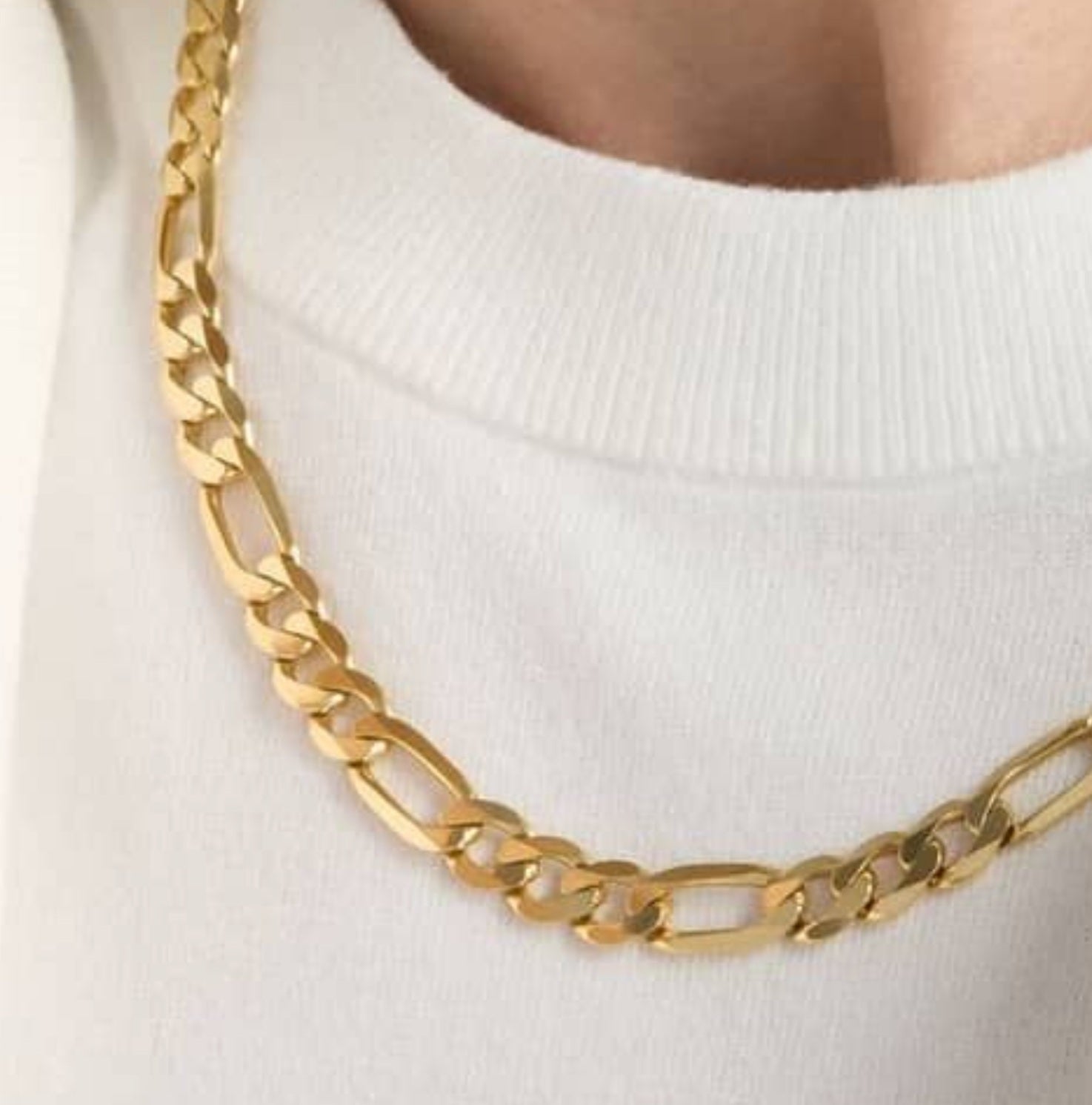 Man wearing 14K yellow gold Figaro chain necklace, 24 inch length, 6 mm width.